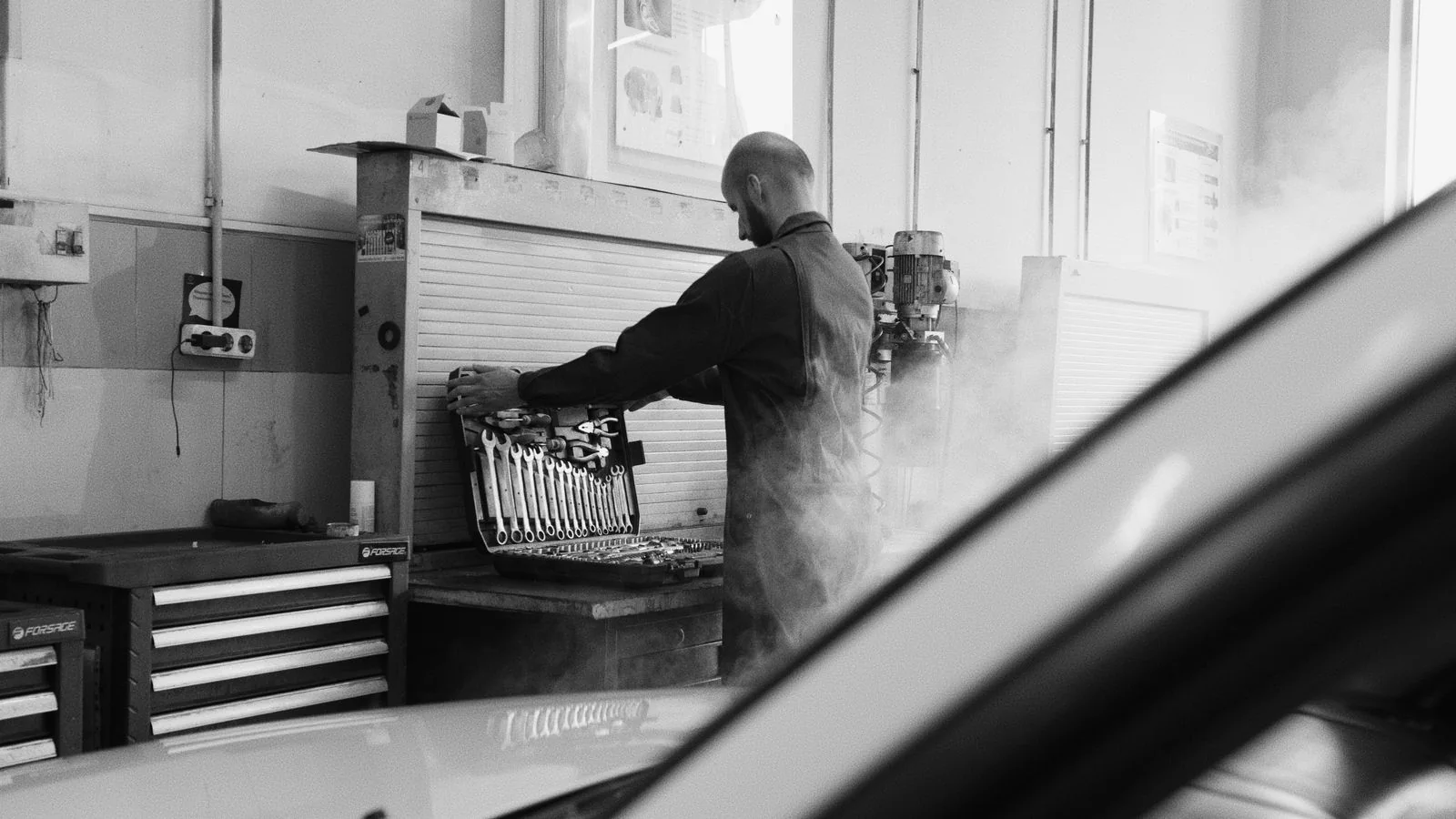 Technician selecting precision tools at a clean workbench