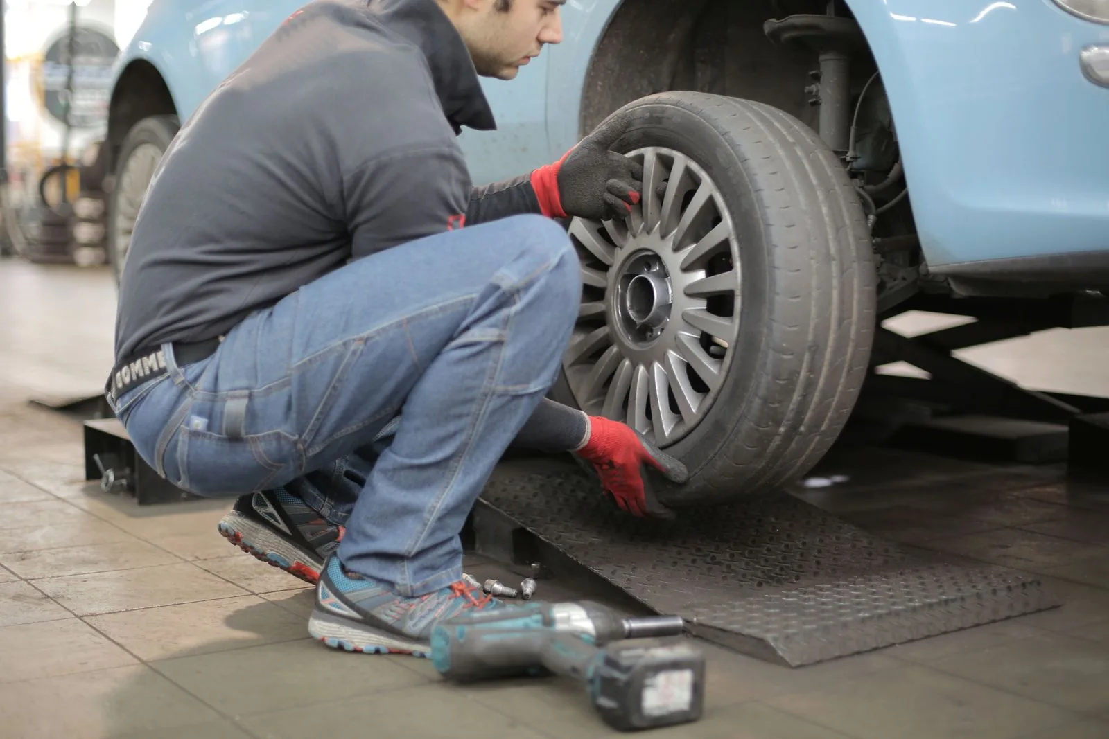 Technician removing a wheel for tire and brake service